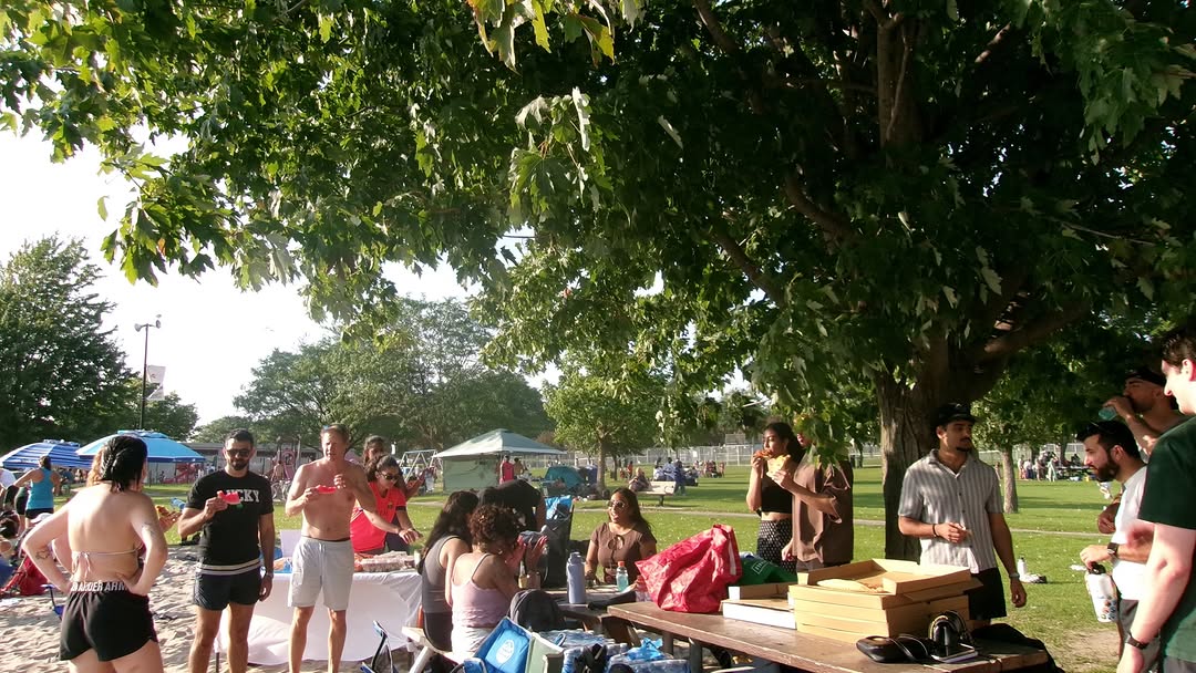 A group gathering under the trees at the first Pretty Neat Stuff event