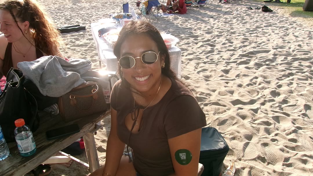 Two attendees smiling at the beach