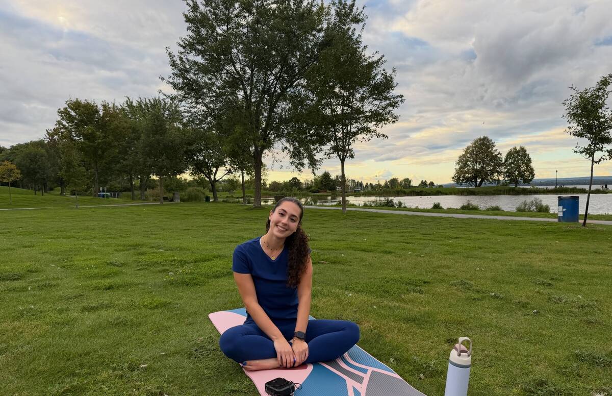 The Pilates instructor smiling on her mat after the class